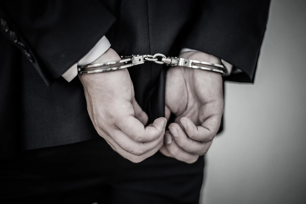 Businessman-Arrested-Handcuffs
