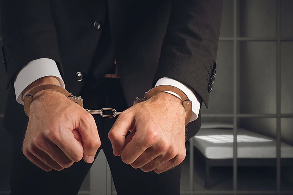 Businessman-Handcuffed-In-Jail
