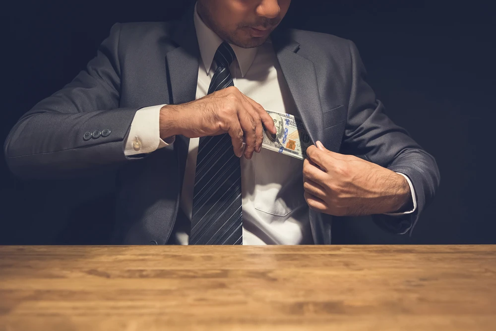Man-Putting-Money-In-Jacket