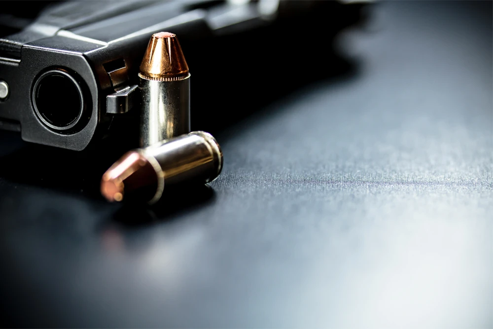Pistol-And-Bullets-Dark-Background image
