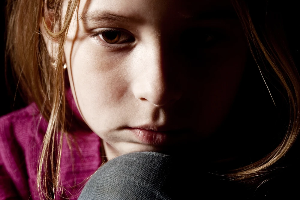 Sad-child-on-black-background image