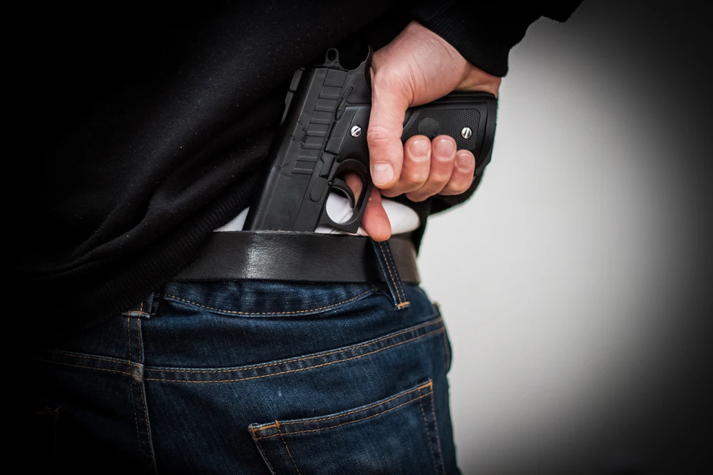 The-Man-Hid-The-Gun-Behind